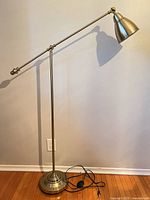 Full view of adjustable gold-tone floor lamp