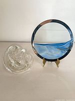 glass knot and round sand art displayed together