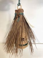 Full view of hanging wicker and pine-needle birdhouse