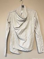 Full view of grey side-zip long sleeve jacket hanging