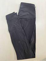 Folded black Lululemon leggings showing overall appearance