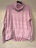 Front view of heathered pink Lululemon Find Your Unwind pullover