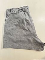 Full view of grey Lululemon shorts side seam and waistband