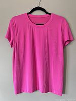 Front view of pink perforated Lululemon Airflow T-shirt on hanger