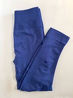 Folded blue Lululemon tights showing waistband and leg
