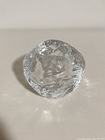 Oblique view of entire clear glass snowball votive holder