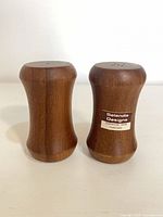 Front view of both teakwood shakers showing grain and label