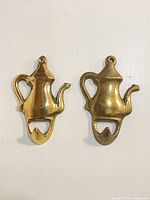Front view of both brass teapot hooks