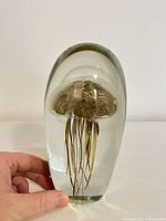 Front view of glass paperweight showing jellyfish detail