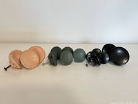 Group view of all 14 wooden knobs sorted by color