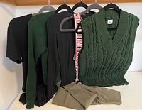 Group shot of all five clothing items on hangers and folded tights