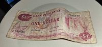 Obverse of Bank of Guyana $1 note showing coat of arms, serial 580736