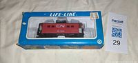 Front view of Life-Like box showing red CN 79249 boxcar inside