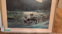 Framed acrylic painting showing full composition with four wolves beside river