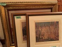 Three framed artworks stacked showing frame styles and sizes