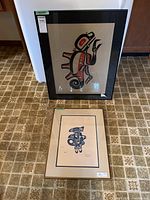 Both framed serigraphs displayed together