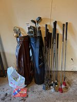 Overall lot with two bags, many clubs, golf balls