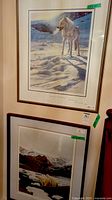 Both framed prints hanging on wall, showing full frames and relative sizes