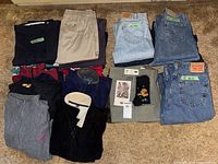 Overview of folded jeans, trousers, fleece tops and socks