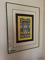 Full view of framed serigraph on wall