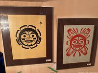 Two framed serigraph prints hanging side by side