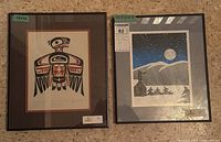 Two framed Roy Henry Vickers serigraphs side by side