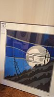 Framed serigraph showing blue sky, silver moon with Indigenous bird motif, silhouetted landscape