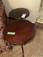 Two matching round side tables showing relative size and placement