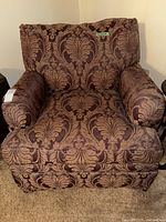 Front view of upholstered armchair showing overall style and pattern