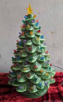 Front view of ceramic Christmas tree showing lights and star