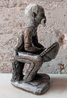 Front view of soapstone elder man figurine holding bowl