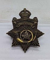 Front view showing complete badge design, text and condition