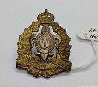 Front view of badge showing design details and wear