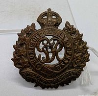 Front view of first brass Royal Canadian Engineers cap badge