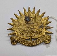 Front view of brass Westminster Regiment cap badge