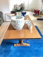 Top view of oak dining table showing rectangular surface and decorative items not included