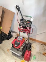 Full view of pressure washer with hose, wand, fuel can
