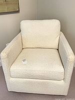 Front view of white swivel armchair