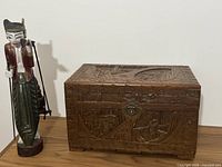 Chest and figure side by side on tabletop