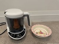 Baby Brezza food maker and Bunnykins bowl side by side
