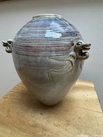 full view of vase front showing glaze and relief patterns