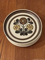 Stack of six Denby Mayflower dinner plates showing floral design and brown rim