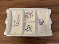 Top view showing segmented platter, fish illustrations and overall condition