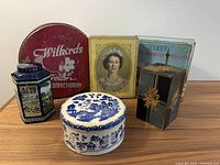 Group shot of all six vintage tins on tabletop