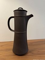 Front view of matte brown stoneware coffee pot showing shape and overall condition