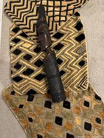 Three Kuba raffia cushion covers and carved wood figure stacked