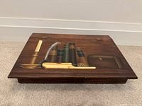 Closed lap desk showing painted lid and brass hinges