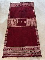 Full view of rectangular red shawl showing overall design and fringe