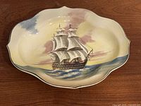 Front view of Royal Doulton platter showing ship design and shape