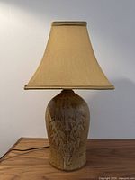 Front view of stoneware lamp with silk shade